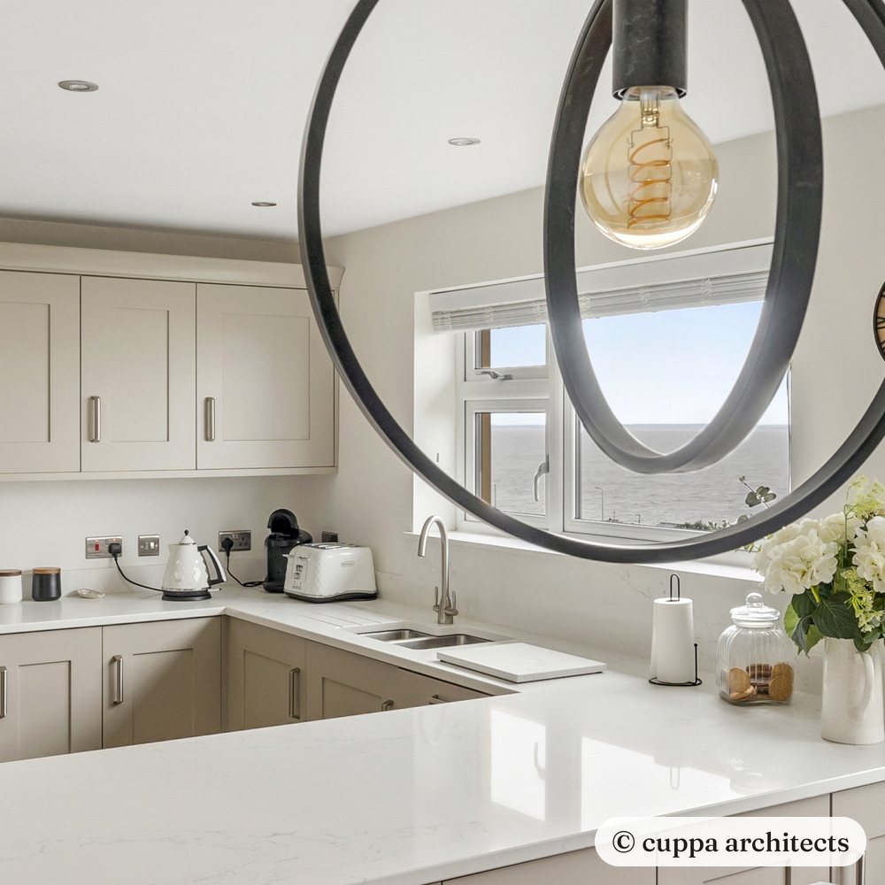 Ring pendant lights hanging over a shaker kitchen