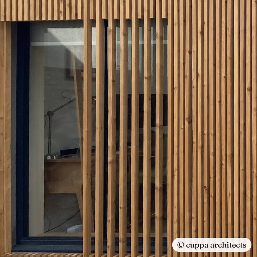 Hit and miss vertical timber battens running across the window of a garage conversion