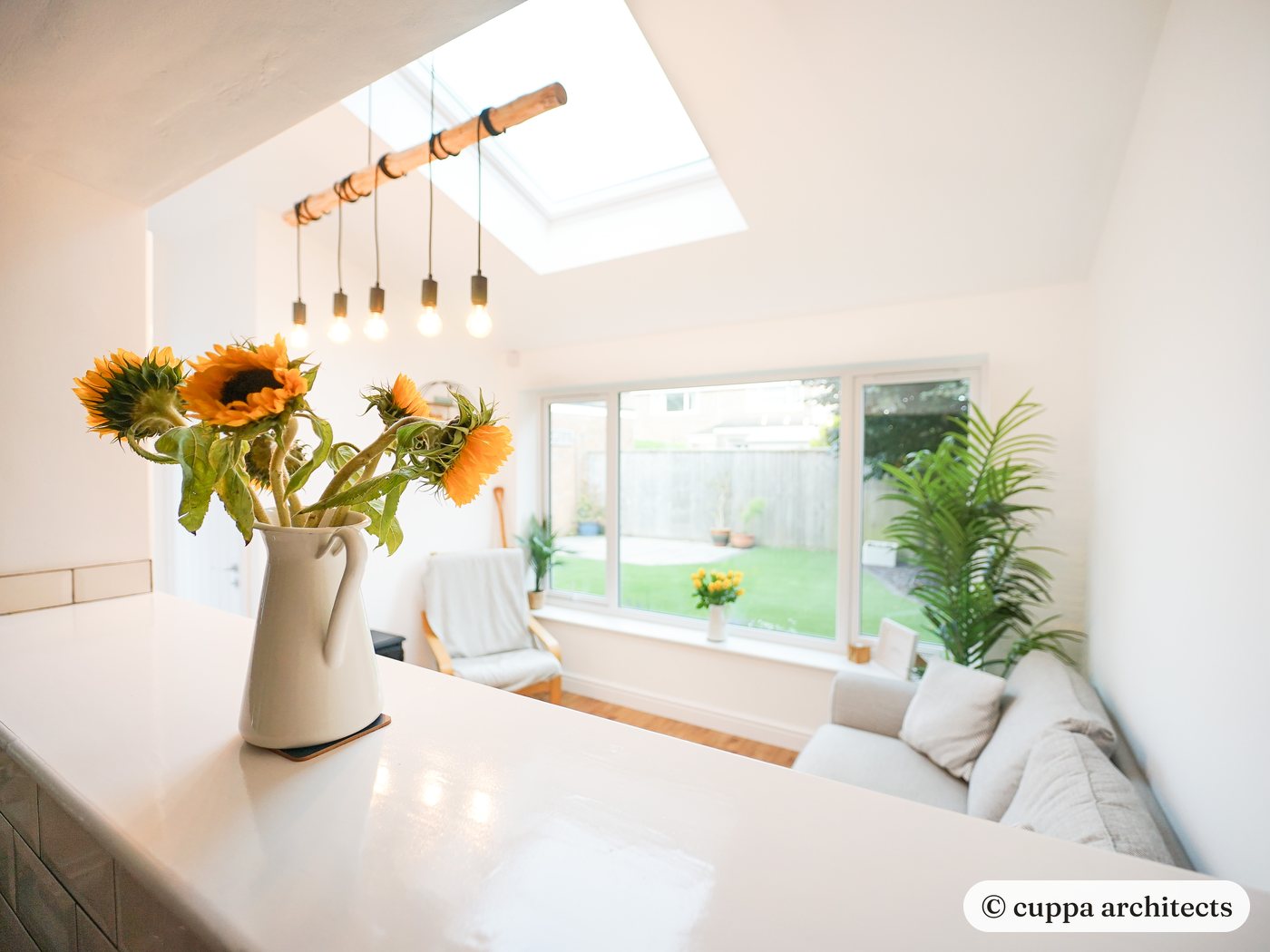 A bright garden room extension with a window seat and rooflights